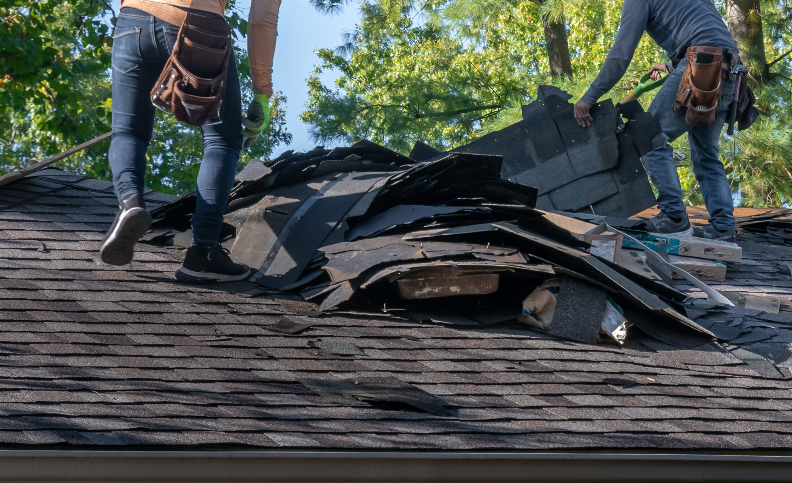 Roofers in Vermont fixing a leaky, storm damaged roof