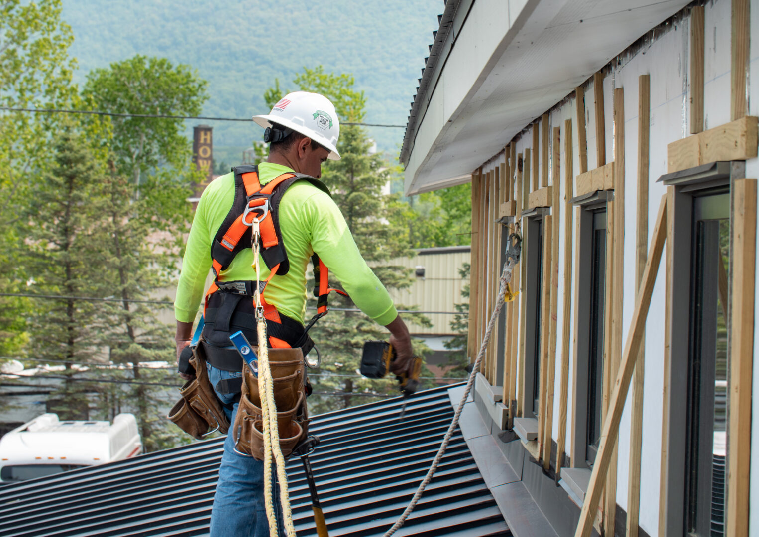 Roofer walking on a roof at a job site in Vermont