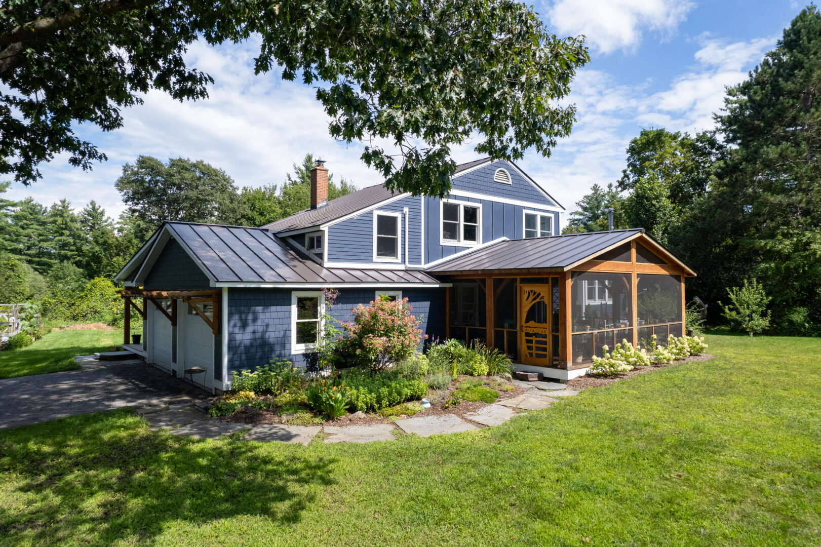 Blue house in Vermont with a stunning standing seam metal roof