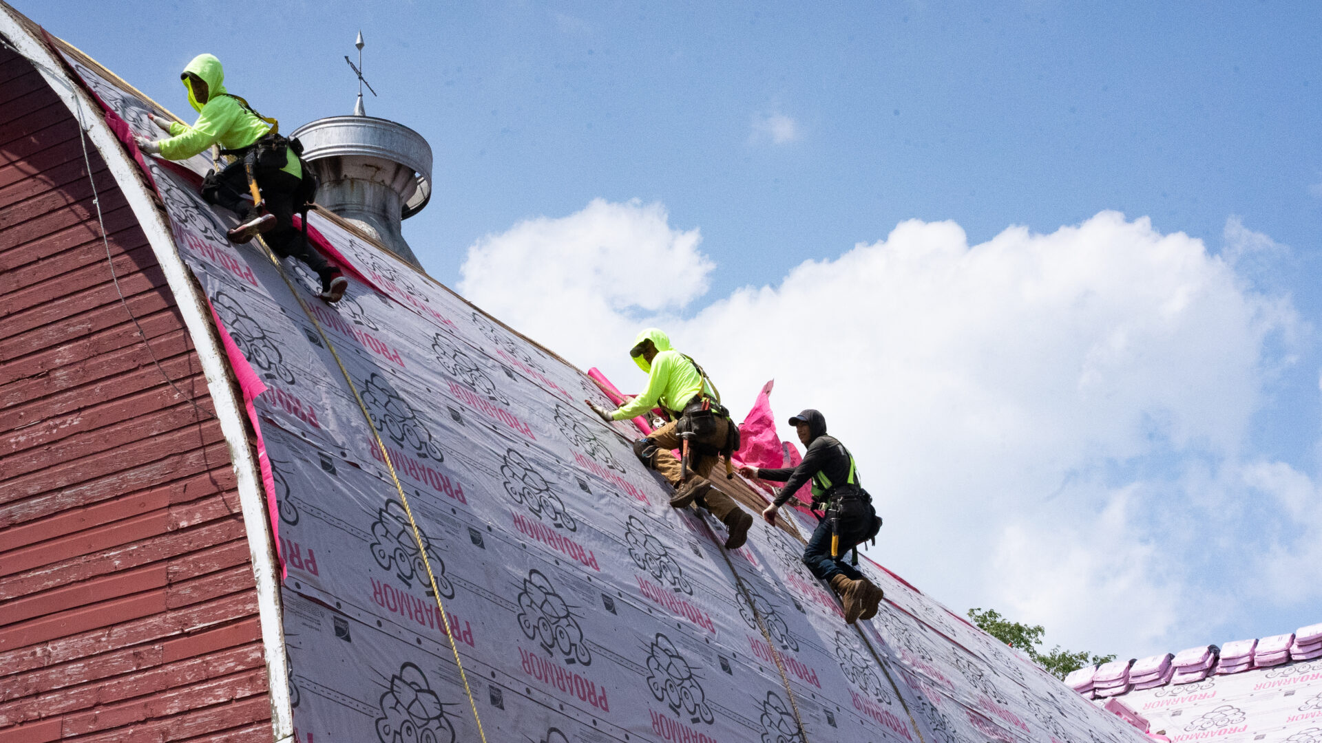 Properly trained roofers working on building a new roof