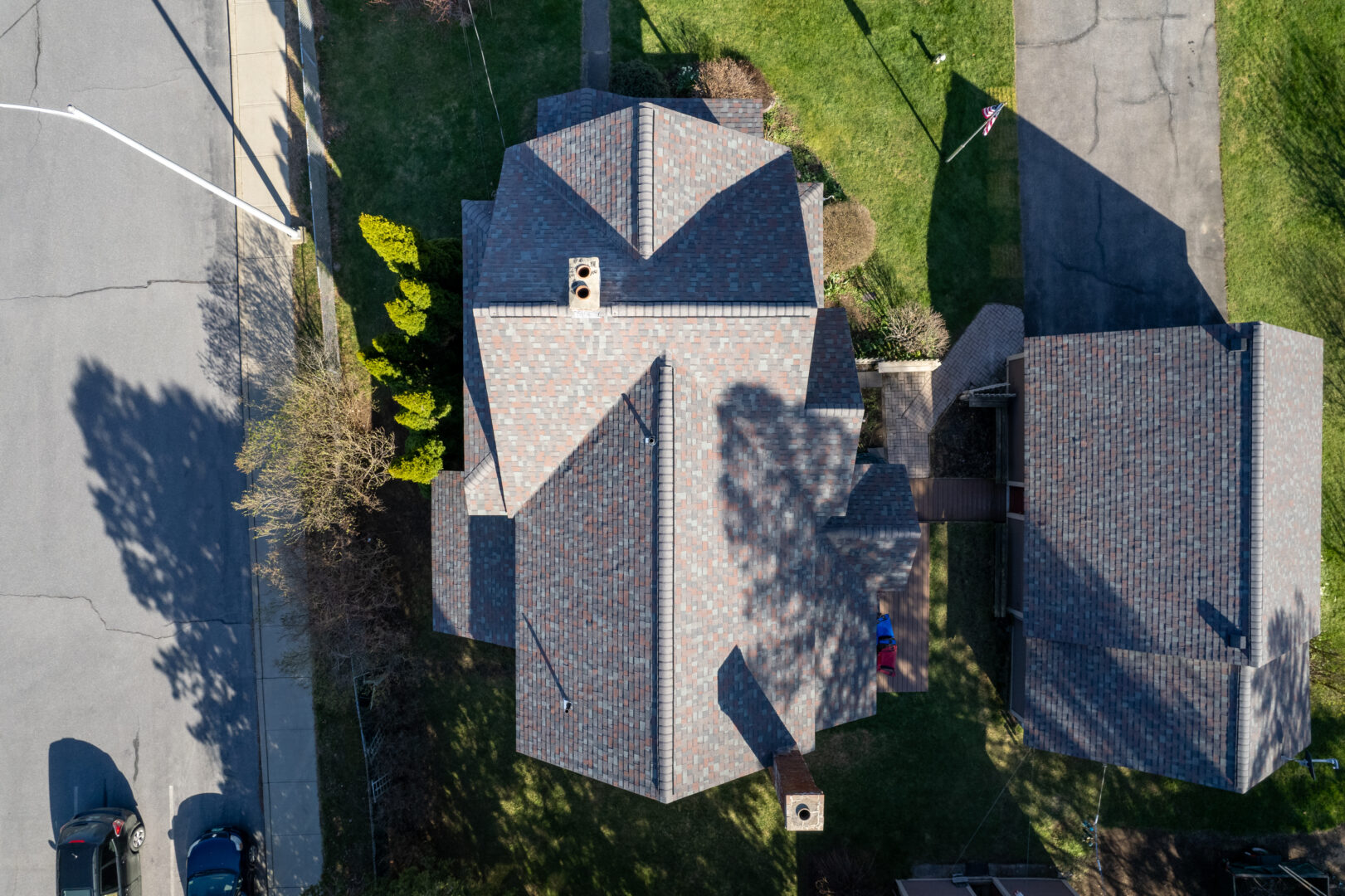 Overhead view of an asphalt shingle roof in Essex Junction, VT that was recently replaced by the Vermont Construction Company Roofing Division.