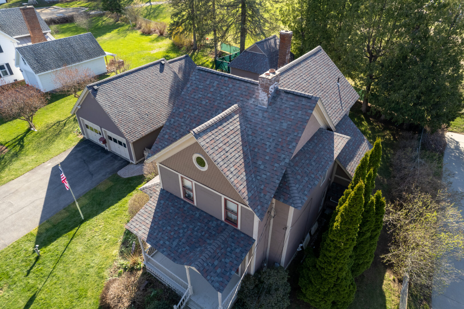 Aerial view of a home with new Owens Corning Architectural Shingles in the Driftwood color scheme. This home had it's roof replaced in Essex Junction, VT.